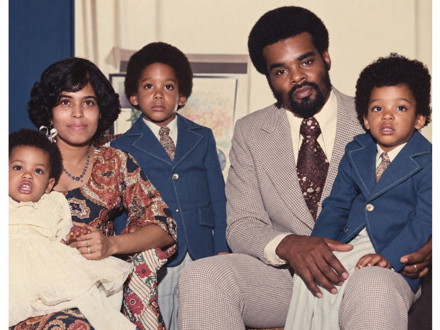 Roosevelt and Rhona seated with three of their children in a family photograph.